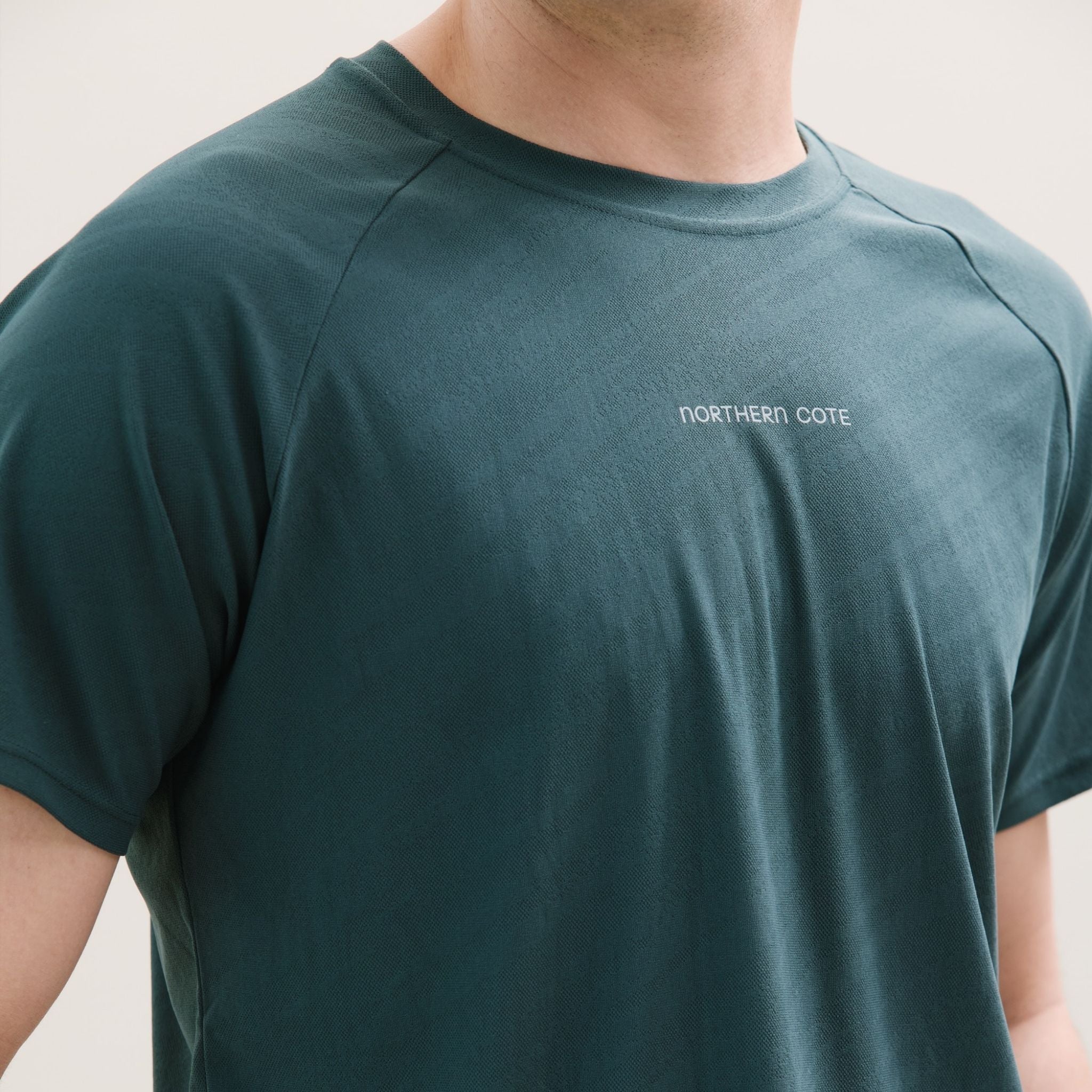 Dark green t-shirt with a logo on a white background