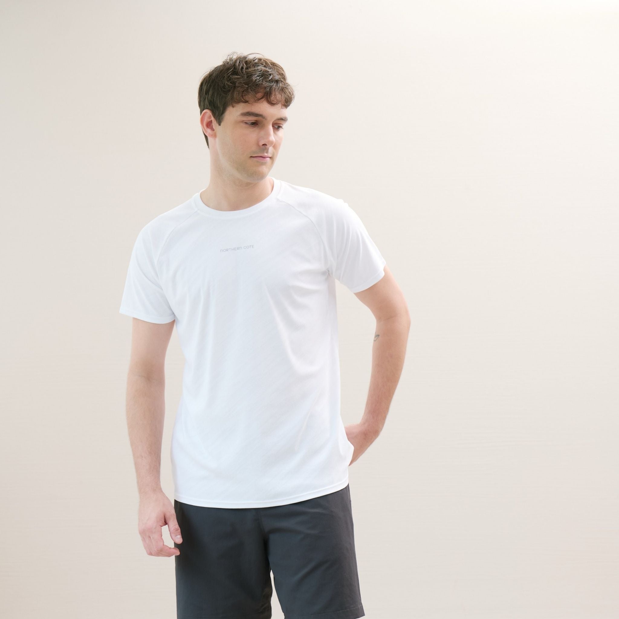 Man wearing a white t-shirt against a plain background