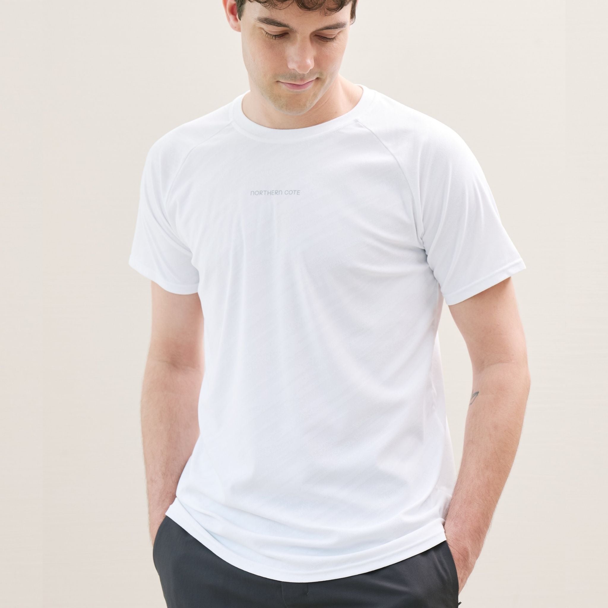 Man wearing a white t-shirt against a plain background