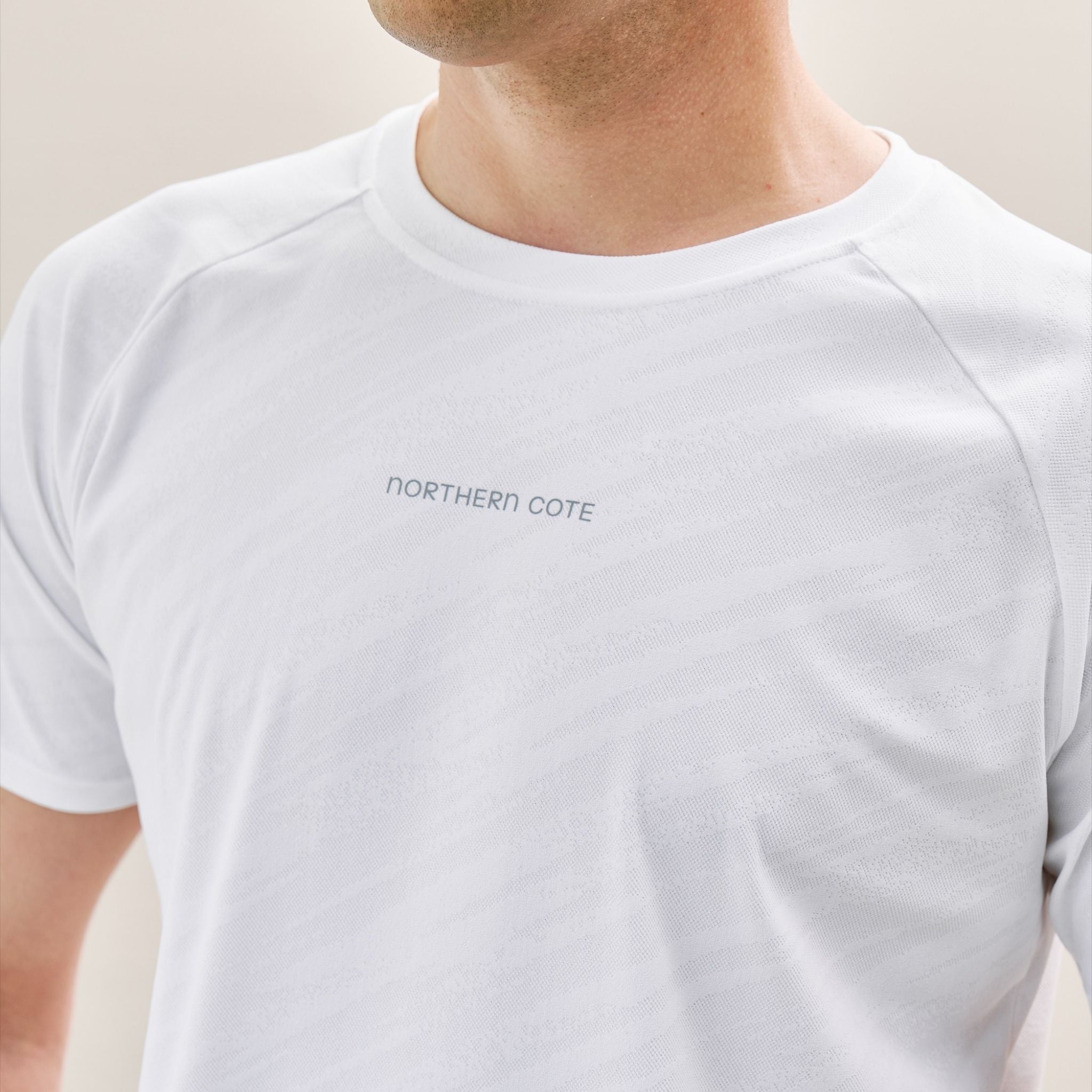 White t-shirt with logo on a plain background