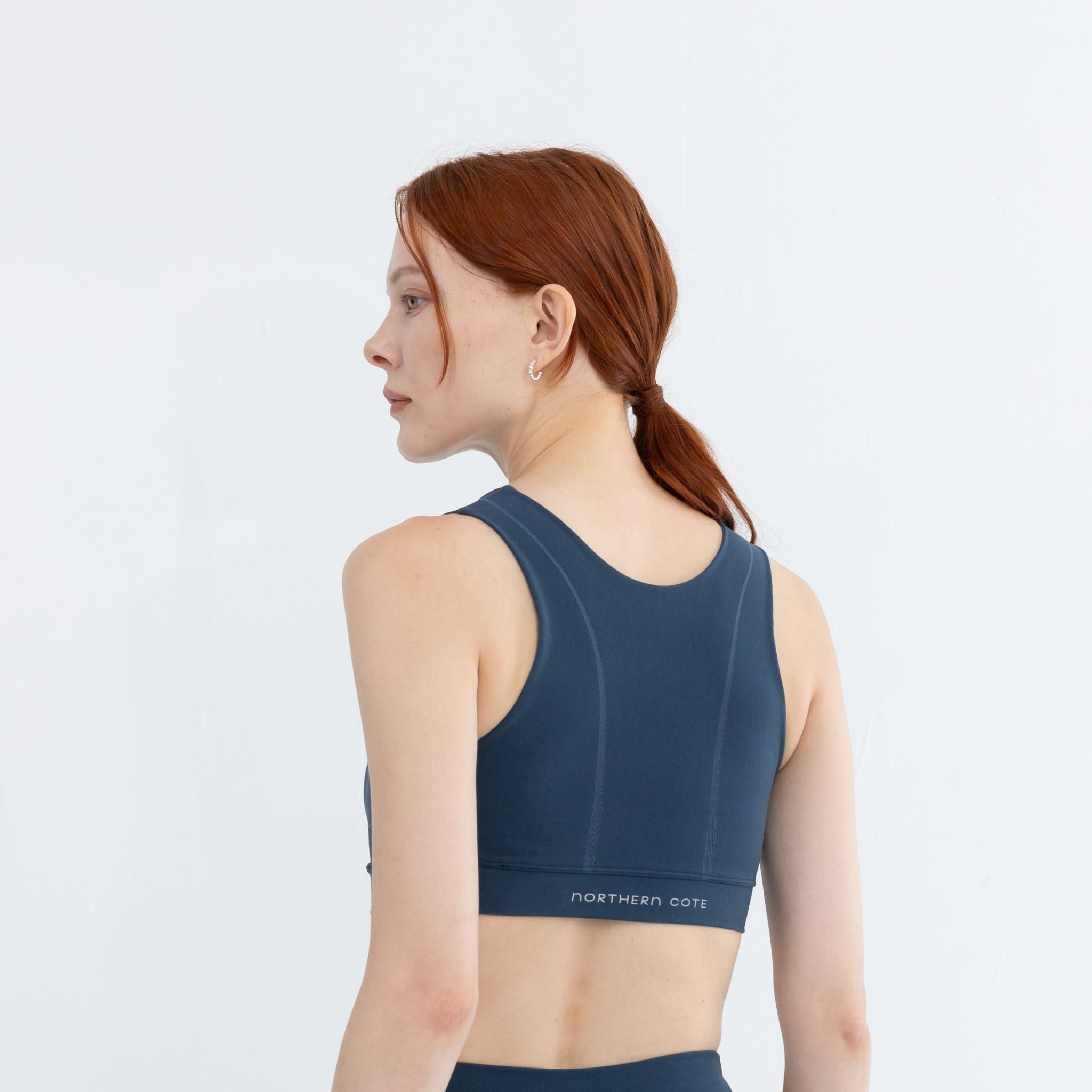 Side pose of model wearing best medium impact workout bra