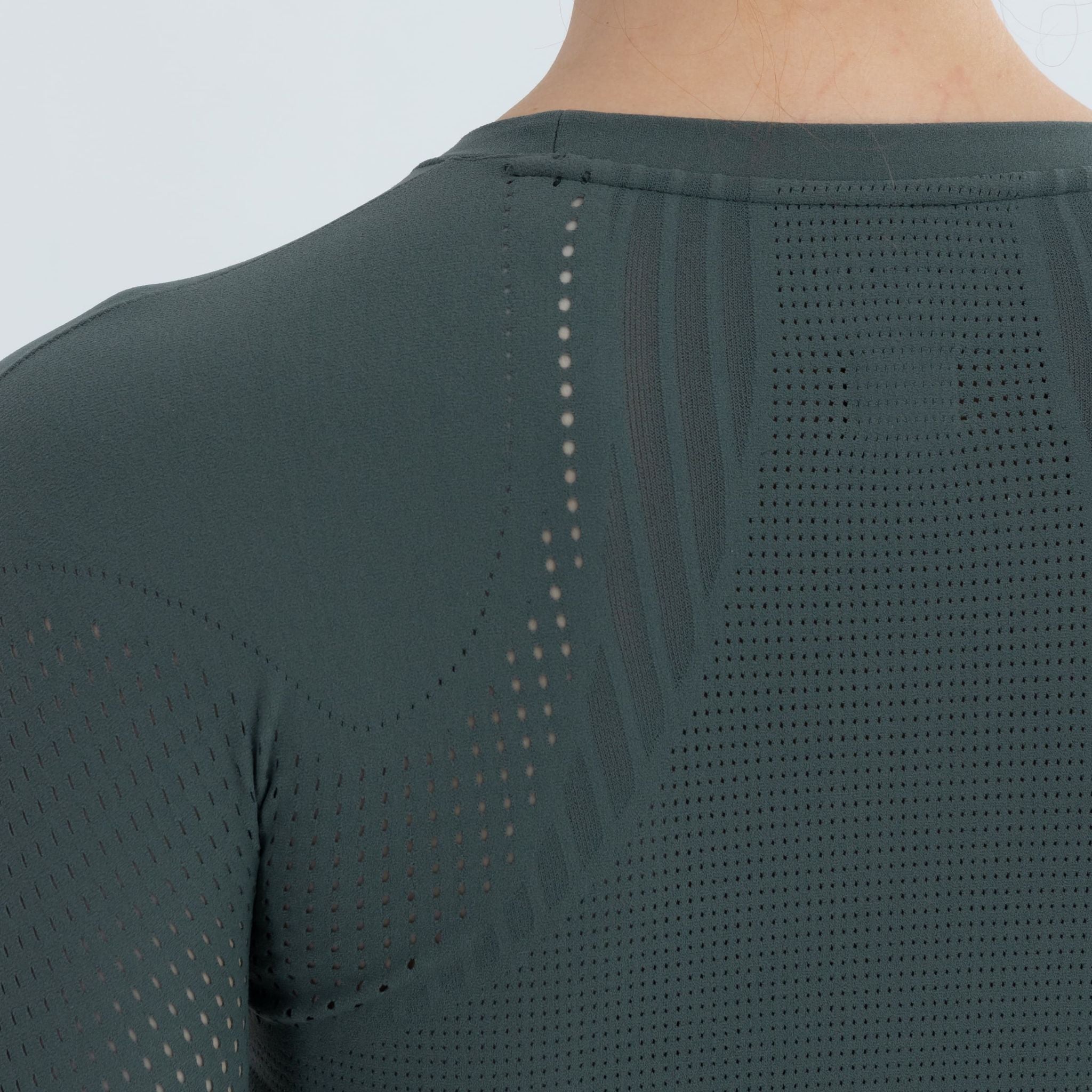 Back view of seamless cropped sweater in pine green on model