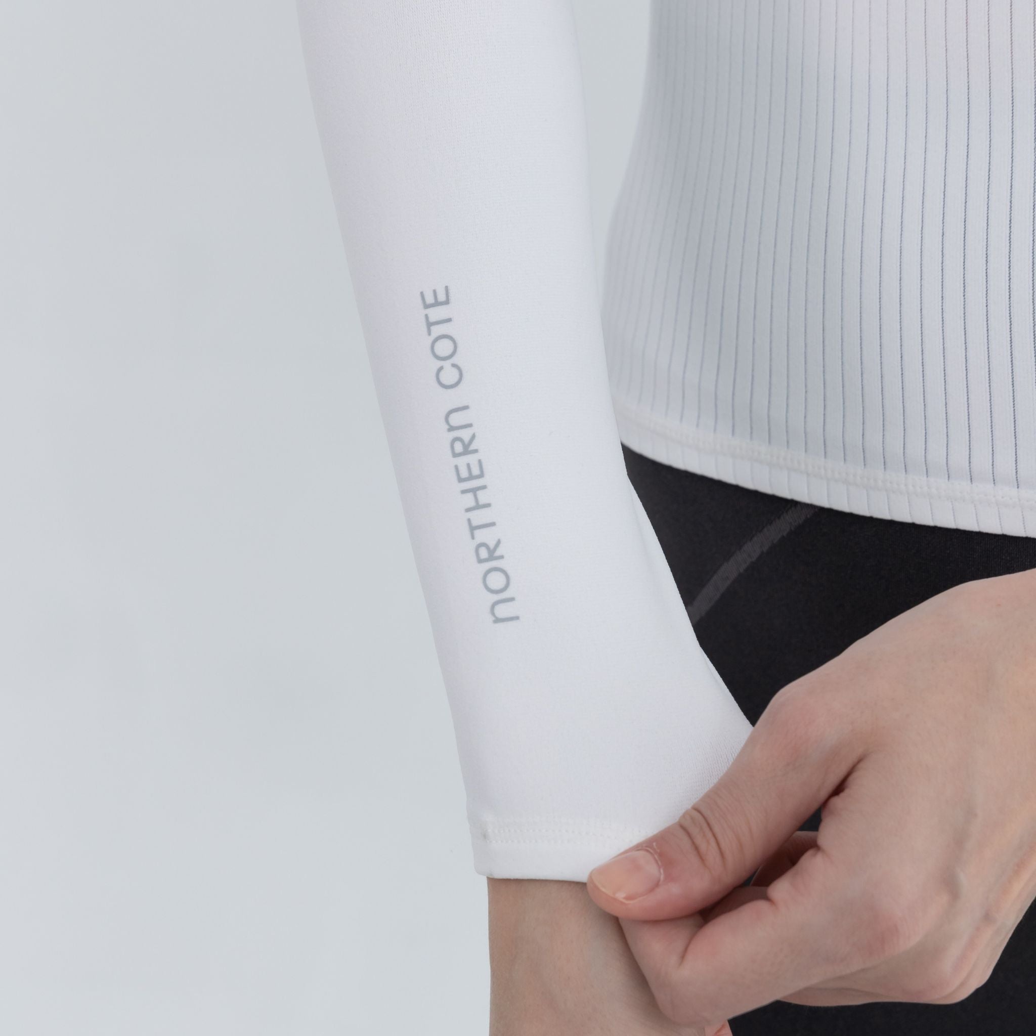 Woman adjusting Training Pullover sleeves pre-workout