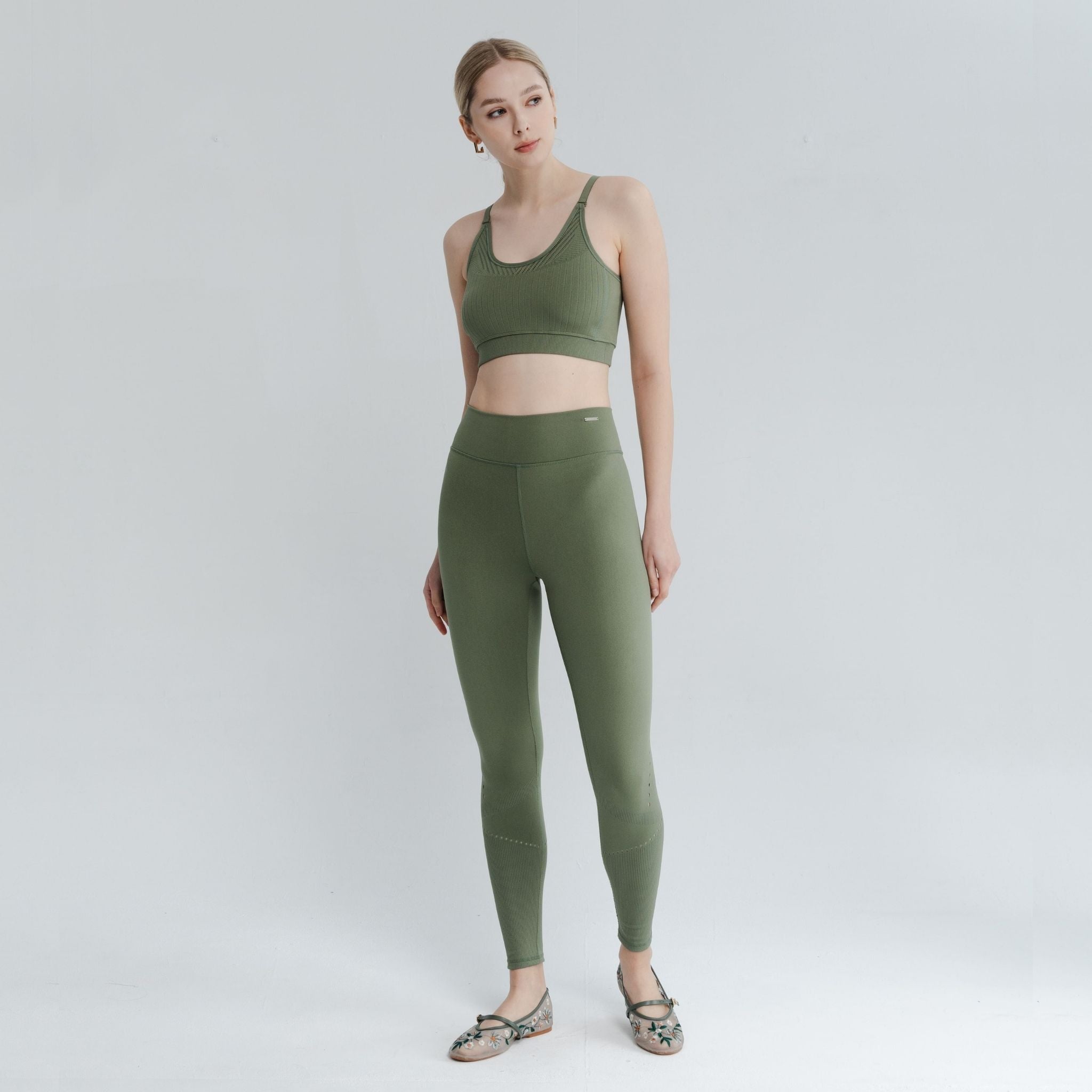 Model posing in a comfortable back bra with an open back design, ideal for layering under low-back tops and activewear.