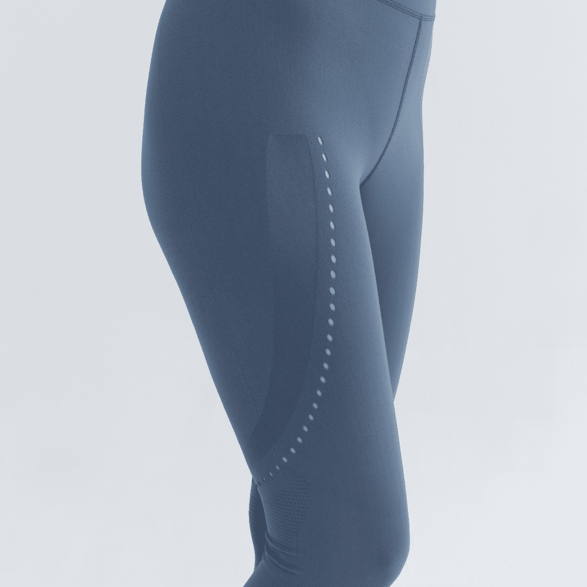 Blue seamless leggings with subtle dot pattern along the side of the thigh.