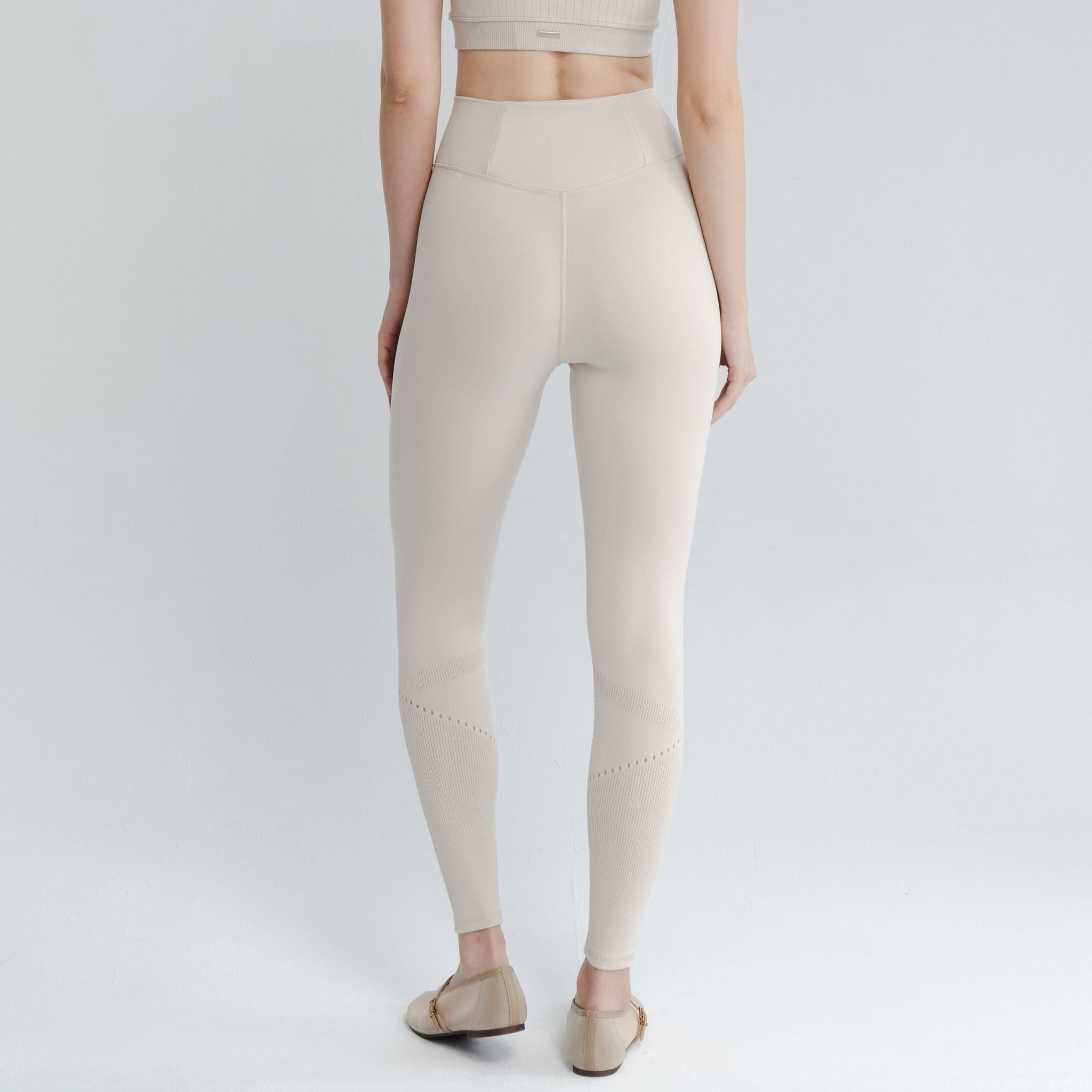 Model wearing sculpting leggings with tummy control waistband