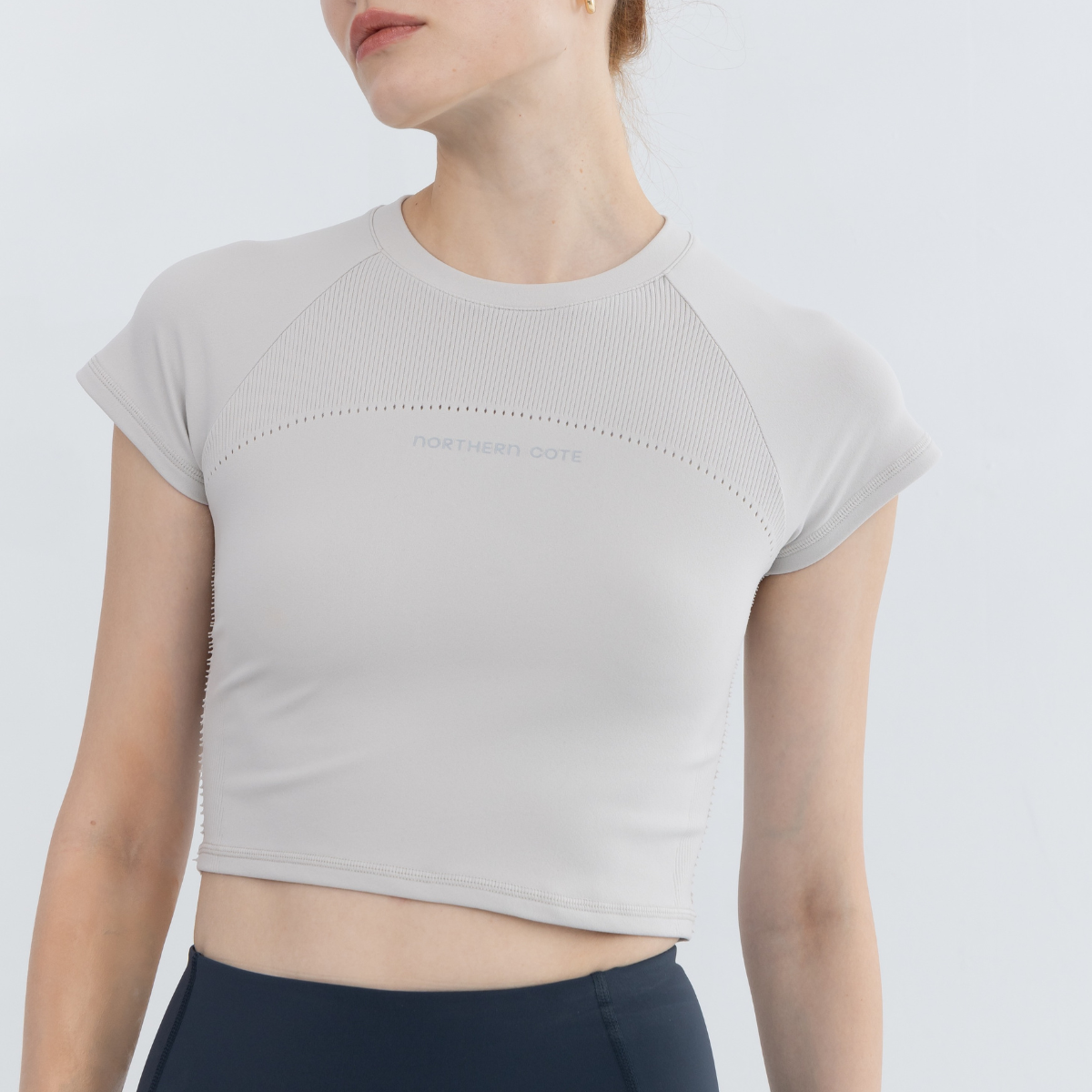 Close-up of armhole and shoulder seams on seamless crop tops for women