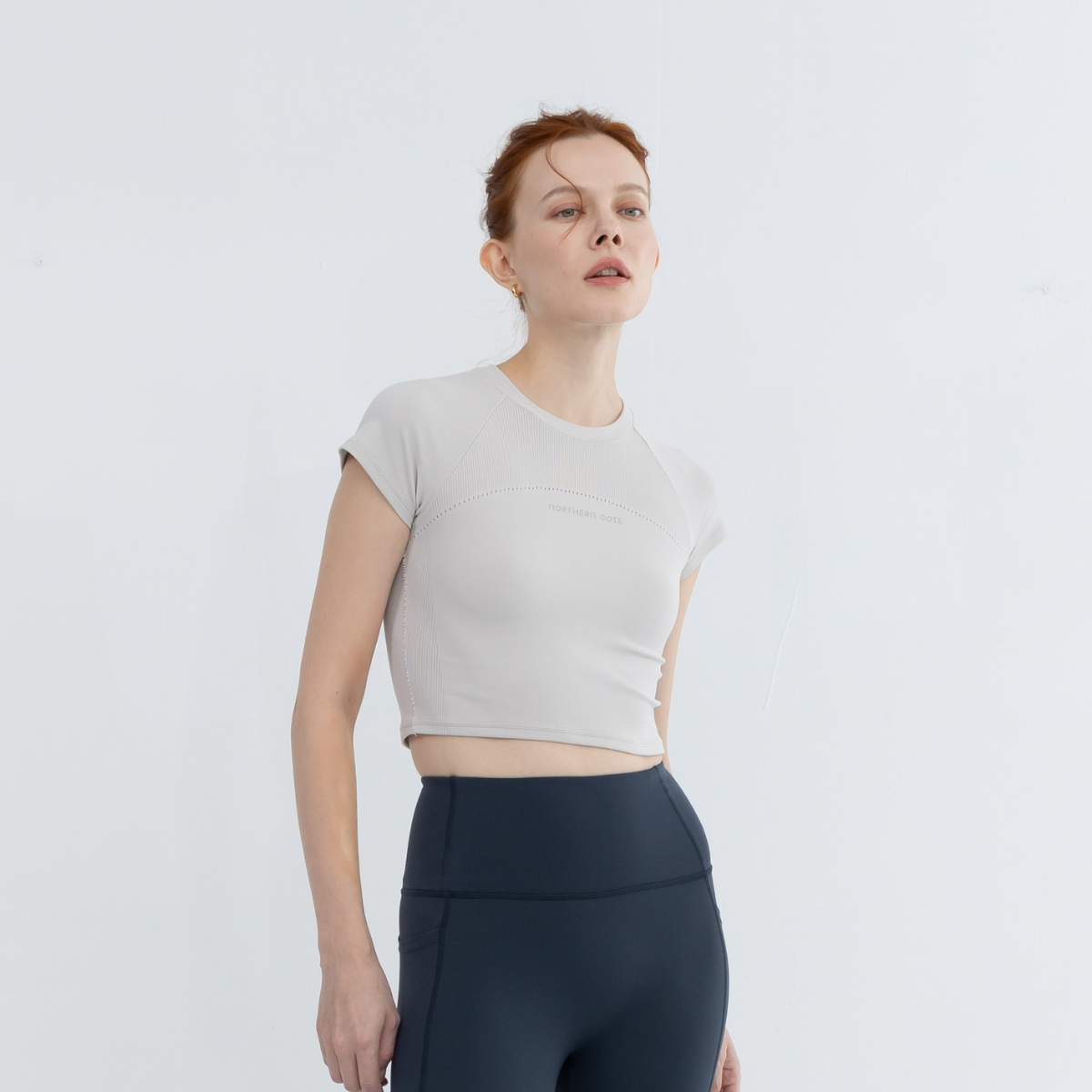 Woman lounging in seamless top and joggers, showing casual styling versatility