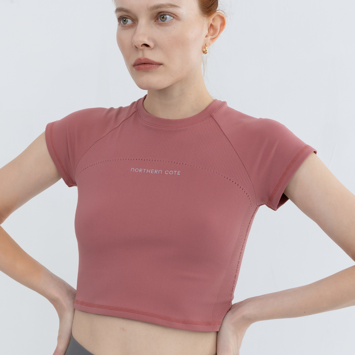 Model stretching seamless crop top demonstrating flexibility and comfort