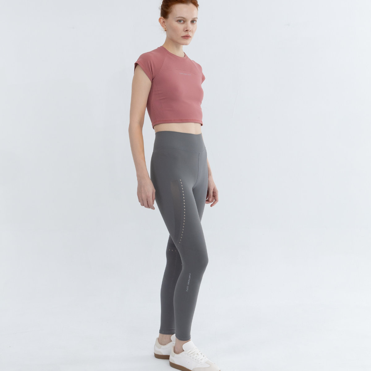 Active lifestyle scene with model jogging in seamless crop tanks outfit