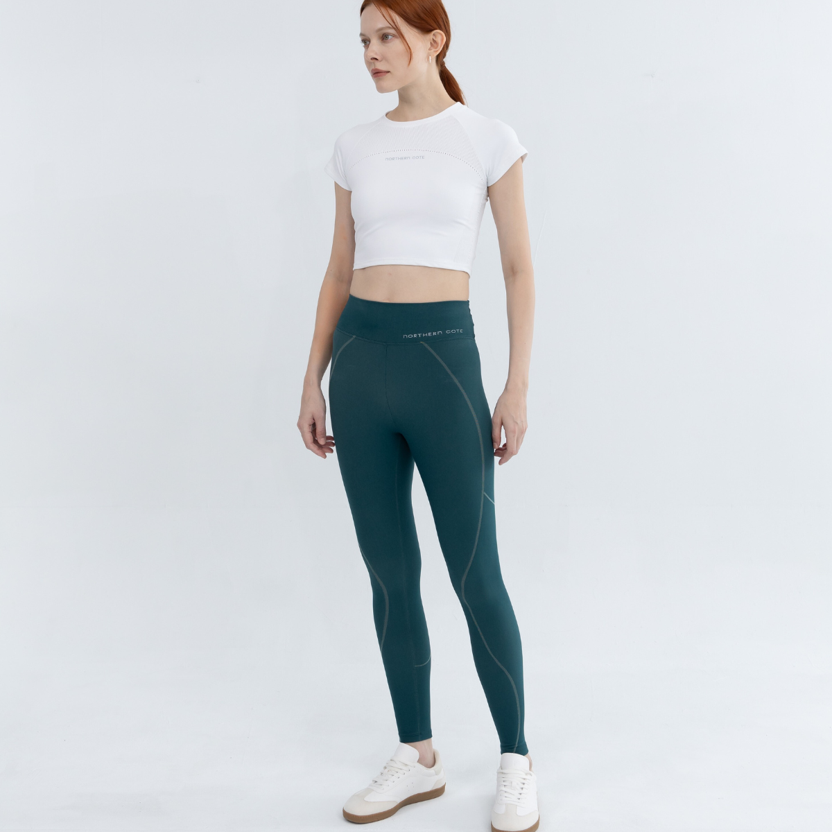 Front view of women's seamless crop top showcasing flattering tight fit and crew neck design