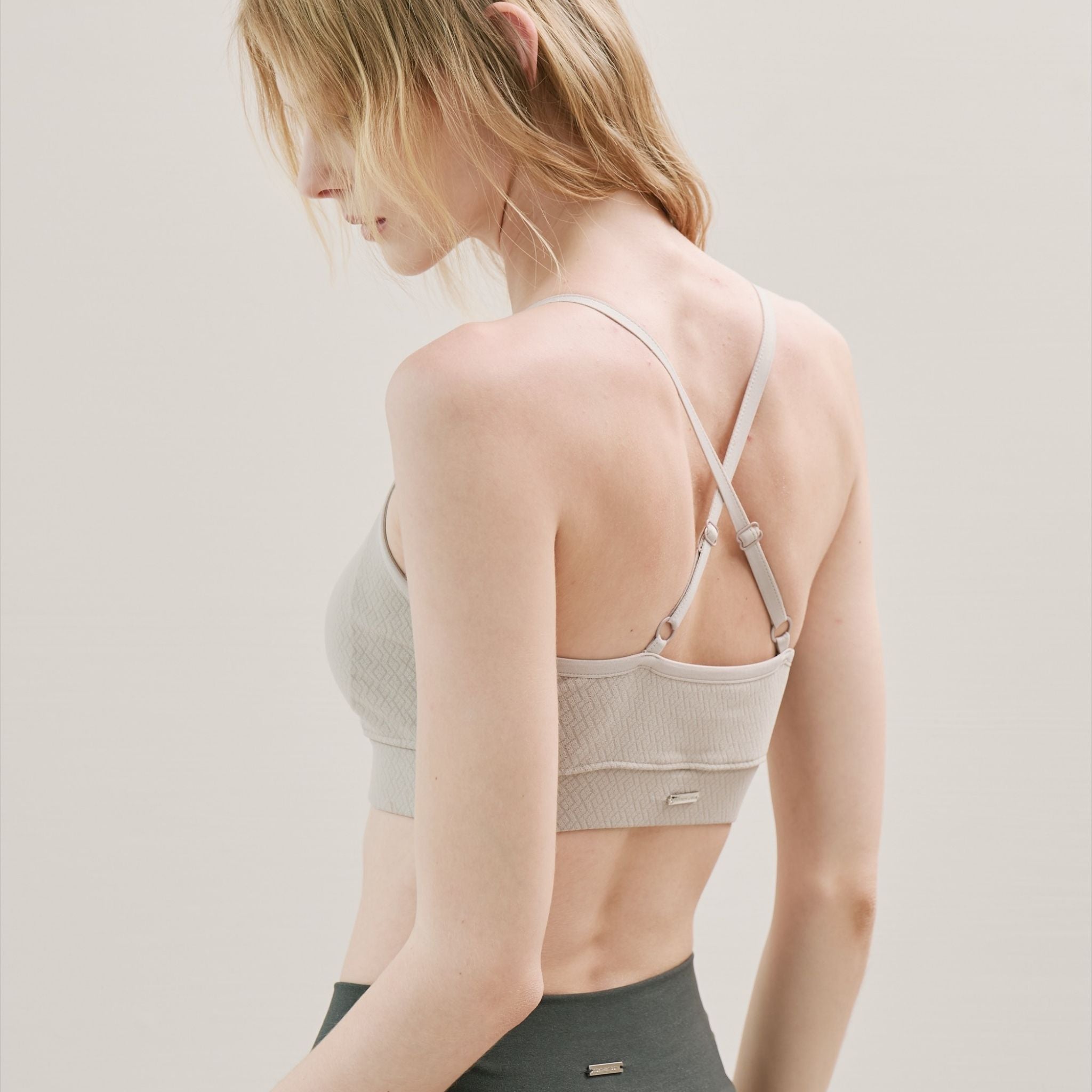 Beige Wireless Cross Back Bra styled with leggings for everyday wear.