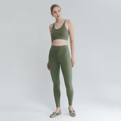 Model posing in a comfortable back bra with an open back design, ideal for layering under low-back tops and activewear.