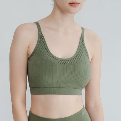 Woman wearing adjustable light impact bra for yoga