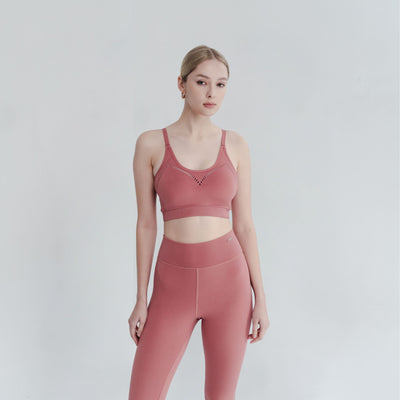 Model wears lightweight support bra with open back – breathable design for effortless movement