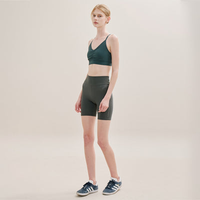 Full-body view of model in cross back  Sports Bra and activewear set for workout.