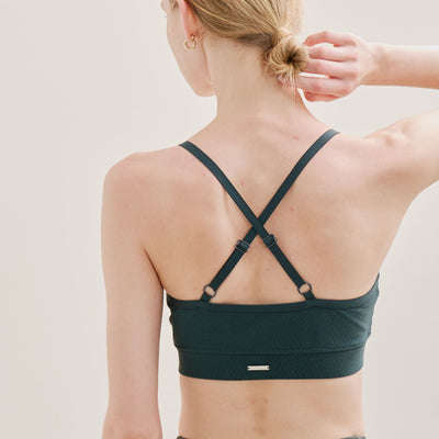Back detail of green Wireless Cross Back Bra with flexible cross straps.